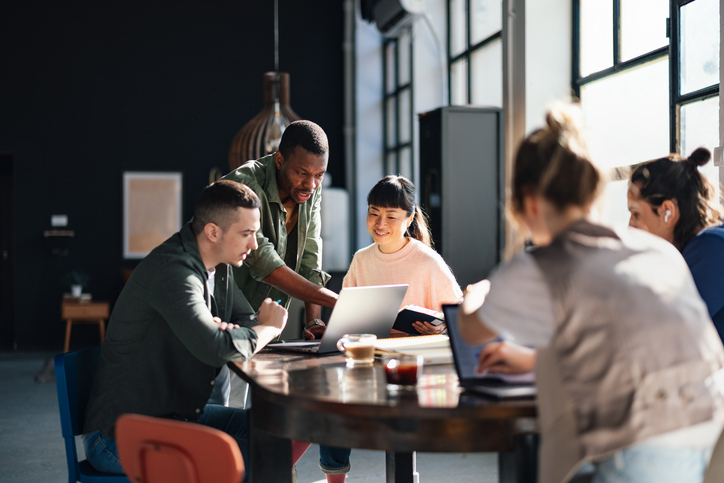 a group of office workers gathered around a table